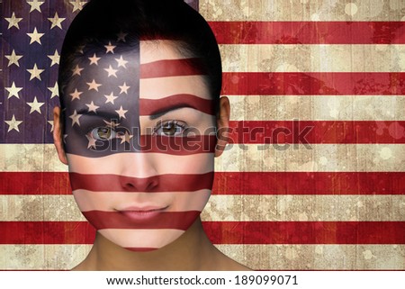 Composite image of beautiful england football fan in face paint against usa flag in grunge effect