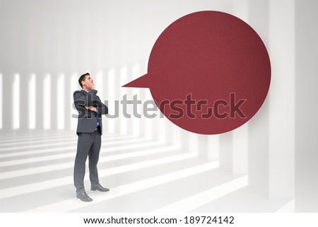 Thinking businessman with speech bubble against curved white room