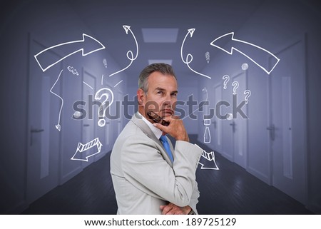 Thinking businessman against bright hallway with several doors