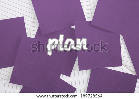 The word plan against purple paper strewn over notepad