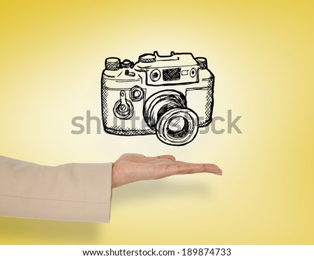 Female hand presenting camera doodle against yellow vignette
