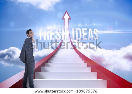 The word fresh ideas and smiling businessman standing against red steps arrow pointing up against sky