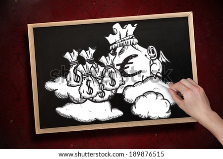 Composite image of hand drawing money bags with chalk on chalkboard with wooden frame
