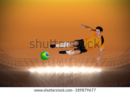 Football player in orange jumping against large football stadium with spotlights under orange sky