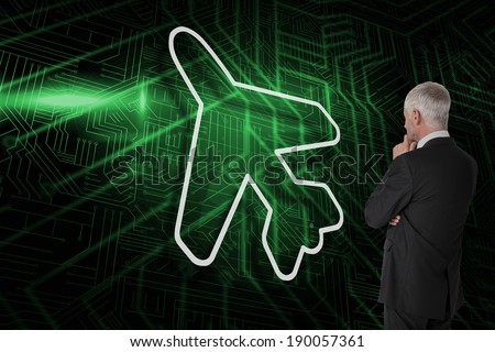Composite image of airplane and businessman watching against green and black circuit board
