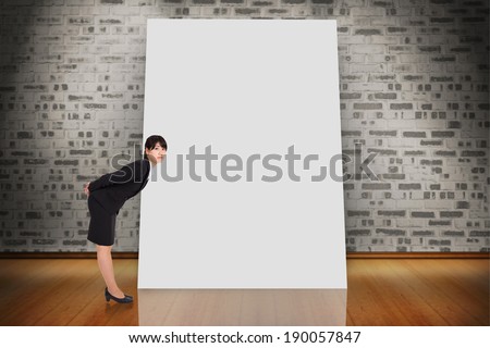 Composite image of serious businesswoman bending bending against white card
