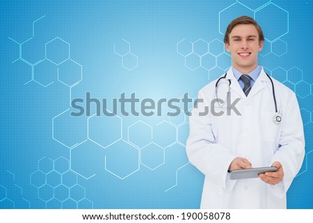 Young doctor using tablet pc against chemical structure in blue and white