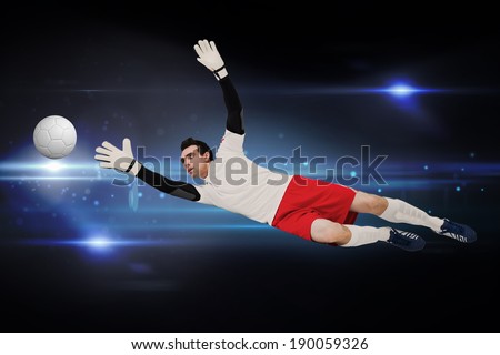 Goalkeeper in white making a save against black background with spark