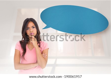 Pretty brunette thinking with speech bubble against bright white room with windows