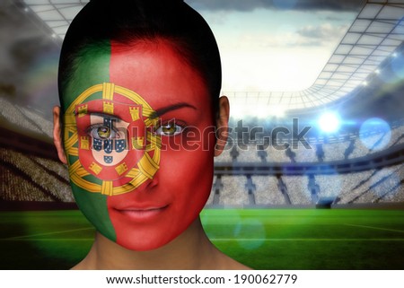 Composite image of beautiful portugal fan in face paint against vast football stadium with fans in white