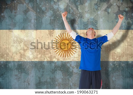 Football player celebrating a win against argentina flag in grunge effect