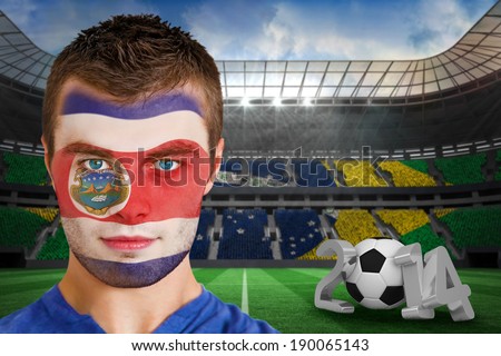 Composite image of serious young costa rica fan with face paint against large football stadium
