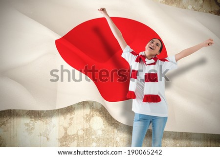 Composite image of excited asian football fan cheering against japan flag