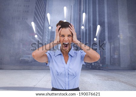 Stressed businessswoman with hand on her head against urban projection on wall