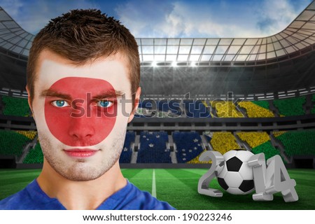 Composite image of serious young japan fan with face paint against large football stadium