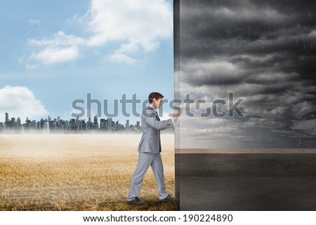 Composite image of businessman pushing away scene of balcony and stormy sky