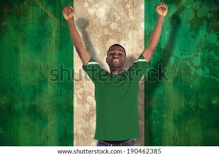 Cheering football fan in green jersey against nigeria flag in grunge effect