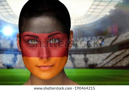 Composite image of beautiful germany fan in face paint against vast football stadium with fans in blue