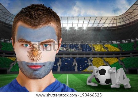Composite image of serious young argentina fan with face paint against large football stadium with brasilian fans