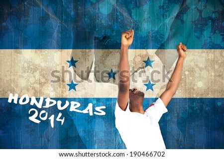 Excited handsome football fan cheering against honduras flag in grunge effect