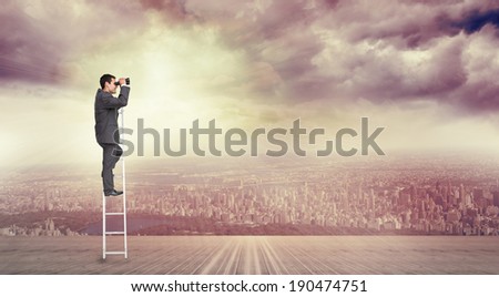 Businessman standing on ladder against balcony overlooking city
