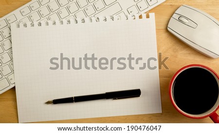 Overhead of graph paper and pen on a desk