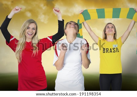 Composite image of various football fans against football pitch under yellow sky