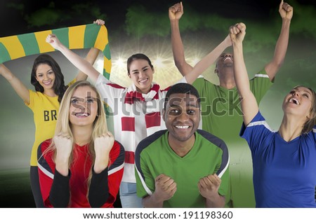 Composite image of various football fans against football pitch under green sky and spotlights