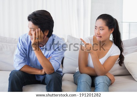 Couple having a dispute on the sofa at home in the living room