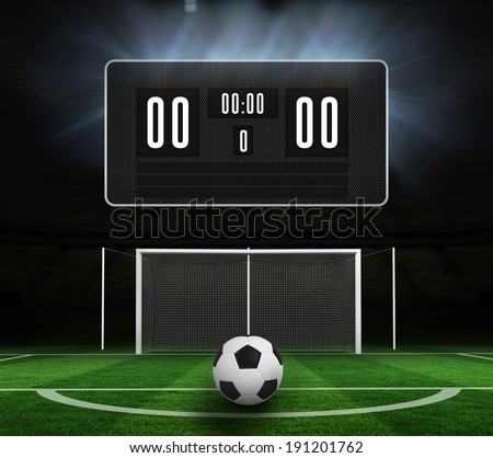 Black scoreboard with no score and football against football pitch under spotlights