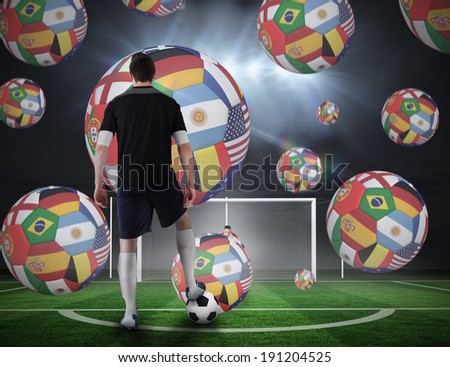 Composite image of football player about to take a penalty against football pitch under spotlights