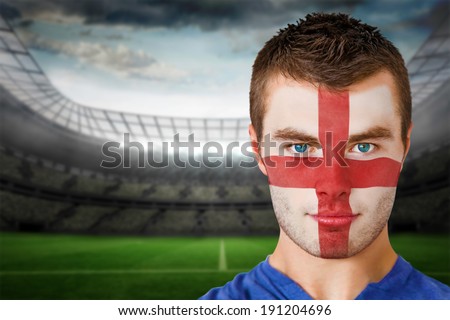 Composite image of england football fan in face paint against large football stadium with lights