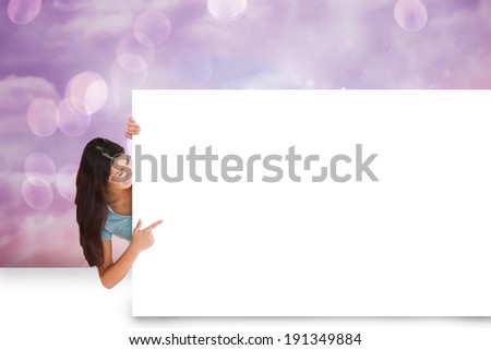 Composite image of pretty brunette showing white card