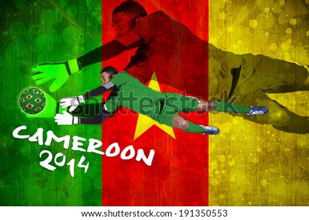 Goalkeeper in green making a save against cameroon flag in grunge effect