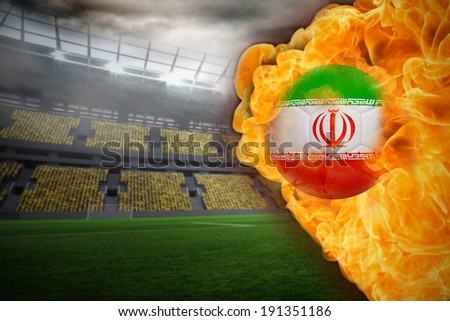Composite image of fire surrounding iran flag football against large football stadium with lights