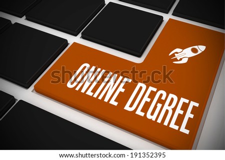 The word online degree and rocket ship on black keyboard with orange key
