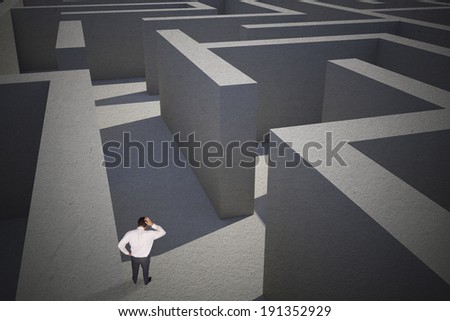 Thinking businessman scratching head against difficult maze puzzle