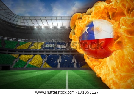 Composite image of fire surrounding chile flag football against large football stadium with brasilian fans