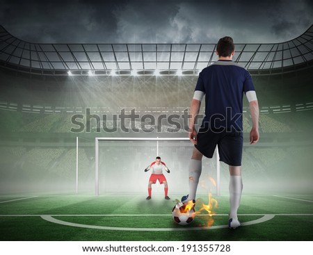 Composite image of football player about to take a penalty against football pitch in large stadium
