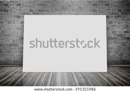 Composite image of white card against grey room