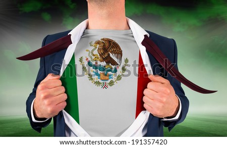 Businessman opening shirt to reveal mexico flag against football pitch under green sky