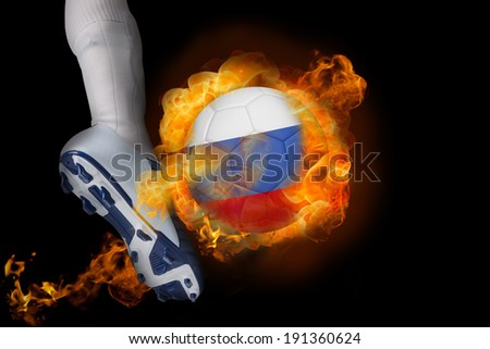 Football player kicking flaming russia ball against black