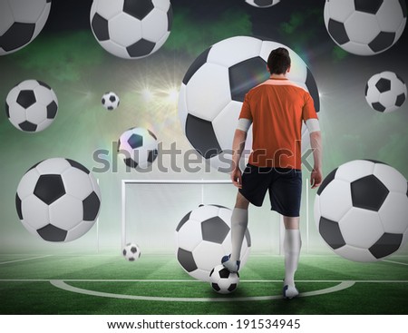 Composite image of football player about to take a penalty against football pitch under spotlights