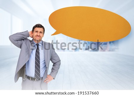 Thinking businessman with speech bubble against city scene in a room