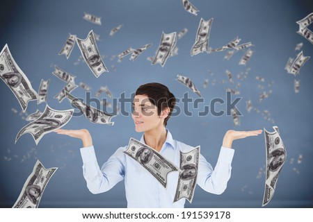 Businesswoman with an open hand to show graphics against dark room