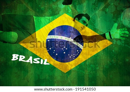 Goalkeeper in yellow making a save against brazil flag in grunge effect