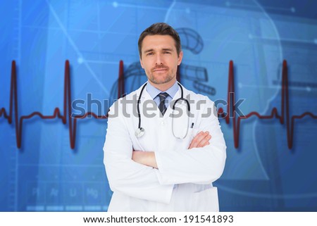 Handsome young doctor with arms crossed against blue medical background with heart diagram and ecg