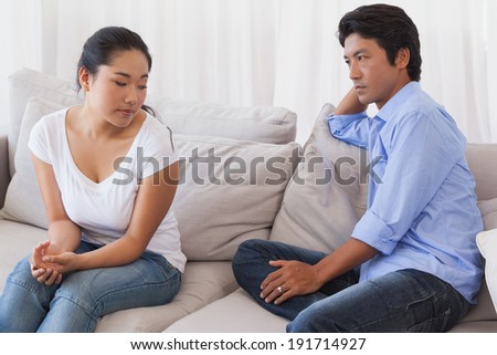 Couple not talking after a dispute on the sofa at home in the living room