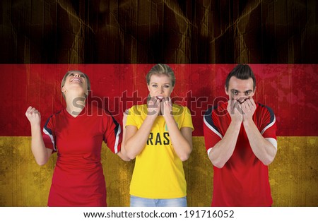 Composite image of various football fans against germany flag in grunge effect
