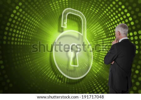 Composite image of lock and businessman looking against green pixel spiral